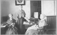 SA0020 - Martha Anderson is on the left, Grace Bowers in the center, and Anna White on the right.  From the North family. Shows 3 women and sewing equipment. Identified on reverse., Winterthur Shaker Photograph and Post Card Collection 1851 to 1921c